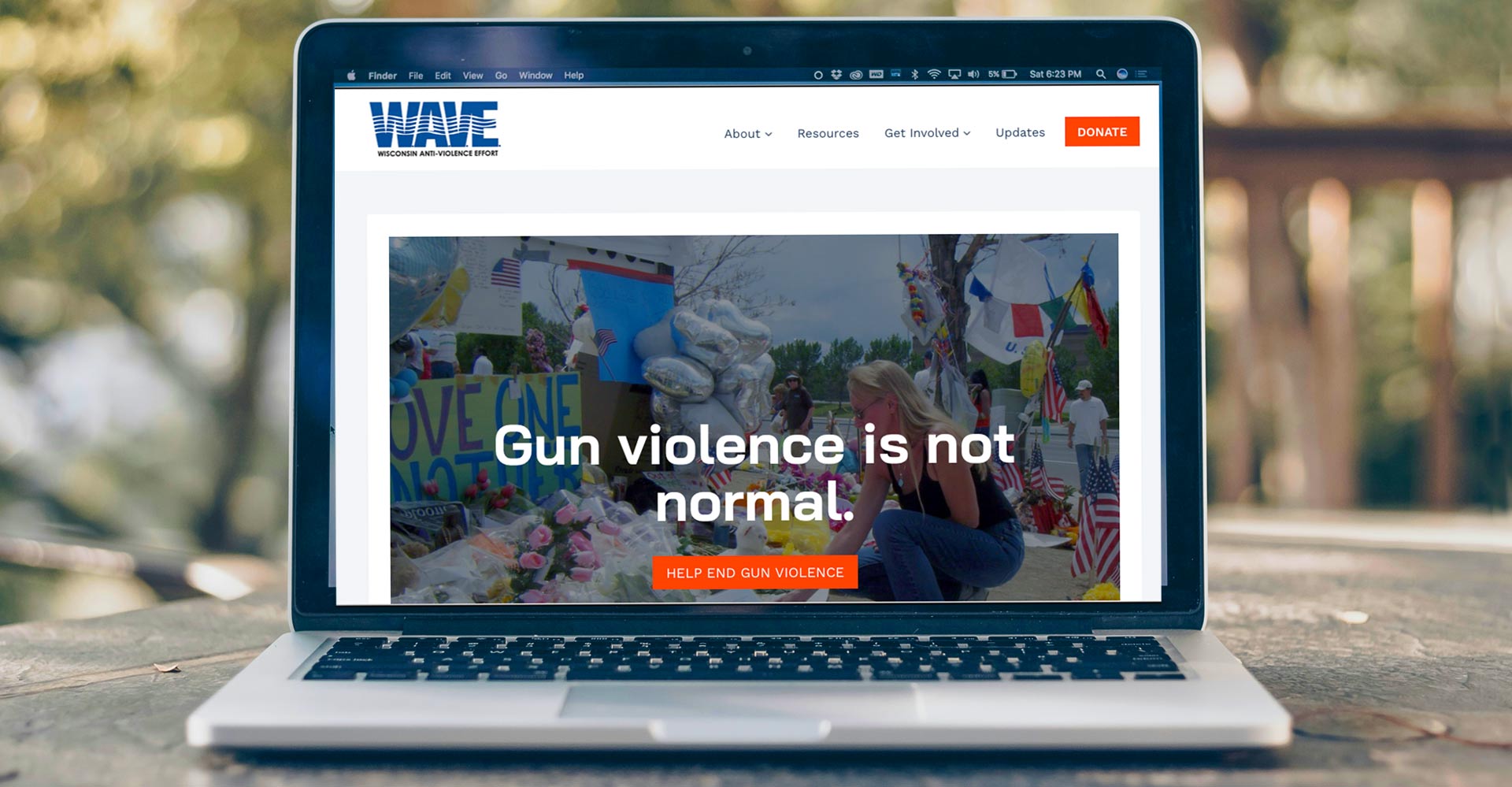 home page of WAVE website on a laptop outdoors